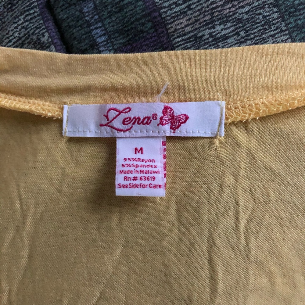 Sleeveless top, fathered at neck, peach colored
